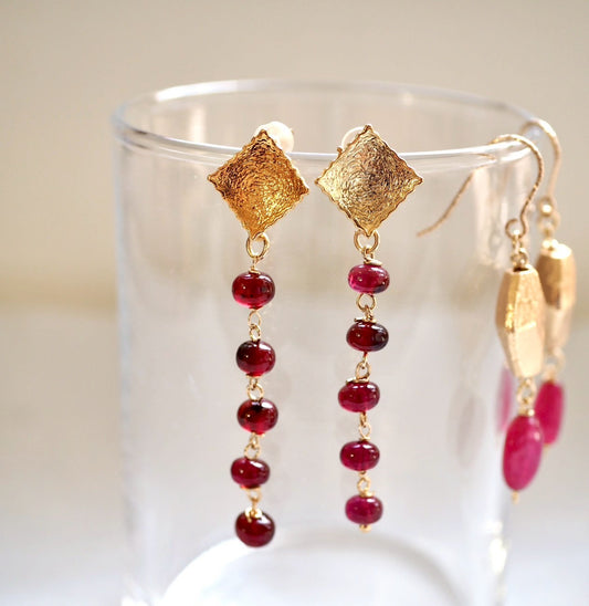 gold motif × ruby pierce